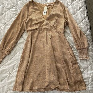 Gold silky dress with black design and cinched long sleeves